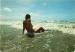 CPM femme nue intgral assise en bord de mer
